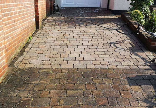 Driveway clean in Bakersfield, Nottingham. Photo taken halfway though to illustrate the difference before/after cleaning.