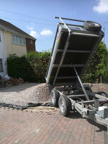 Gravel driveway infill on a once grassed area which was prepared using a compacted stone, a heavy duty weed membrane was then installed before a pink granite chipping was laid, Awsworth, Nottingham