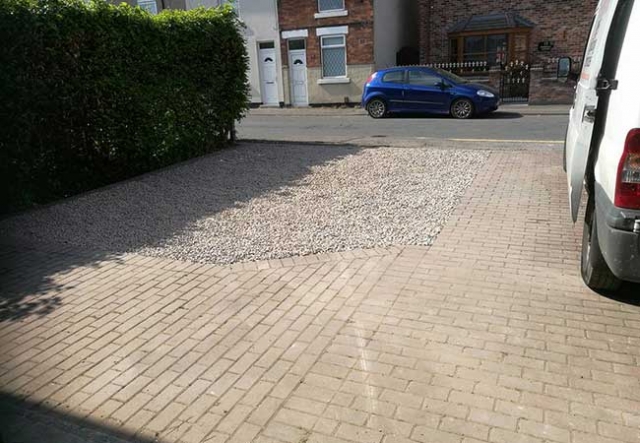 Gravel driveway infill on a once grassed area which was prepared using a compacted stone, a heavy duty weed membrane was then installed before a pink granite chipping was laid, Awsworth, Nottingham