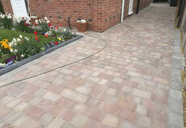 A concrete driveway uplifted, groundwork prepared then a marshalls tegula pavers, mixed harvest and traditional colours used to create this driveway in Hucknall, Nottingham.