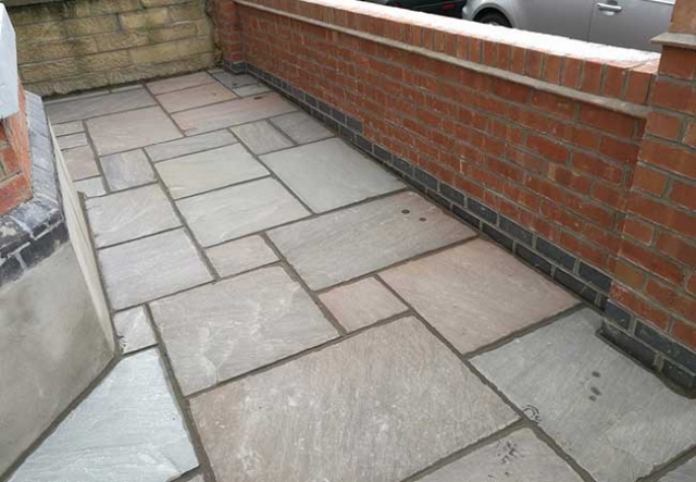 Autumn brown indian sanstone patio we layed behind a front garden wall we built at a job in West Bridgford, Nottingham