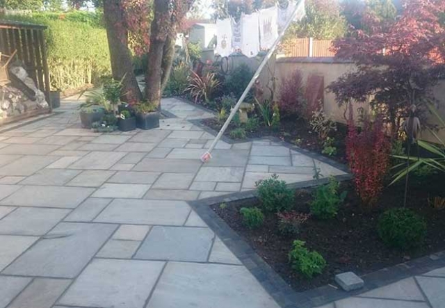 A full rear landscape project in Gedling, Nottingham, using charcoal edging sets installed with a kandla grey indian sandstone infill. Brick butresses built, coping stones on walls relayed and wall rendered.