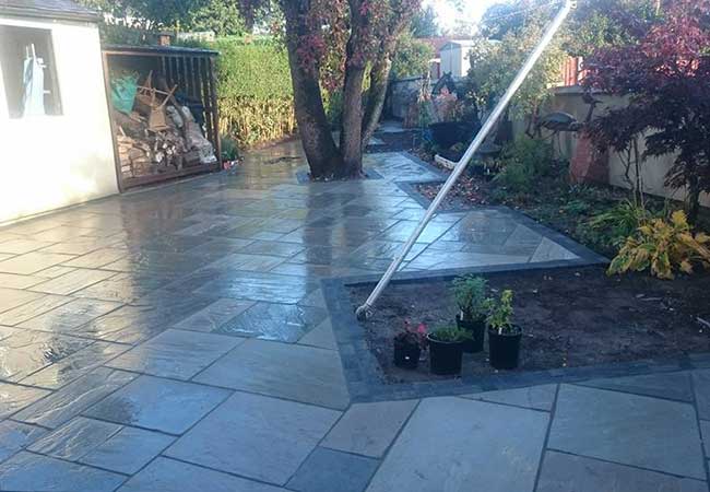 A full rear landscape project in Gedling, Nottingham, using charcoal edging sets installed with a kandla grey indian sandstone infill. Brick butresses built, coping stones on walls relayed and wall rendered.