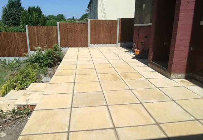 A rear patio we created using simple 600x600mm riven concrete slabs for a job in Ilkeston, Derby